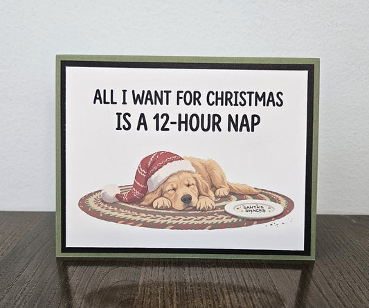 Landscape handmade Christmas card with a sleeping dog in a Santa hat and the words All I want for Christmas is a 12-hour nap.