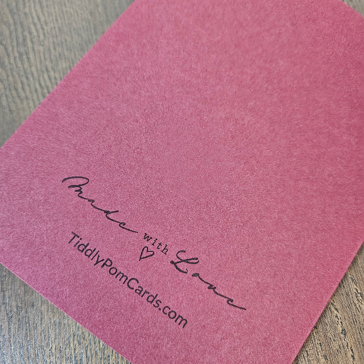 Burgundy back of the handmade Grim Reaper Christmas card stamped Made with Love and TiddlyPomCards.com.