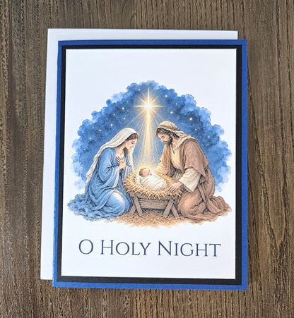 Blue and black layered O Holy Night Christmas card shown with its white envelope