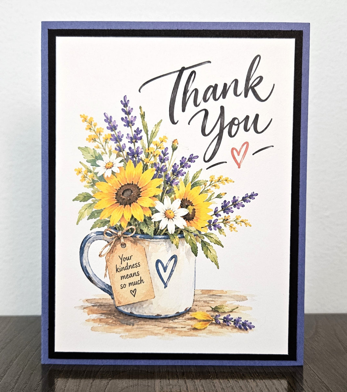 Handmade sunflower and lavender thank you card with a floral mug, black mat and purple base.