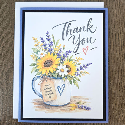 Sunflower and lavender thank you card with its coordinating white envelope on a wooden surface.