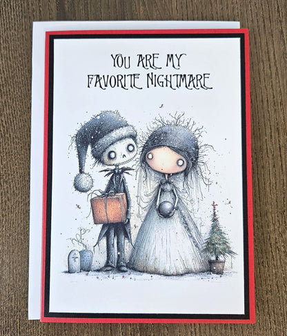 Gothic Favorite Nightmare Christmas card lying flat with its white envelope, showing the spooky couple illustration and red and black cardstock layers.