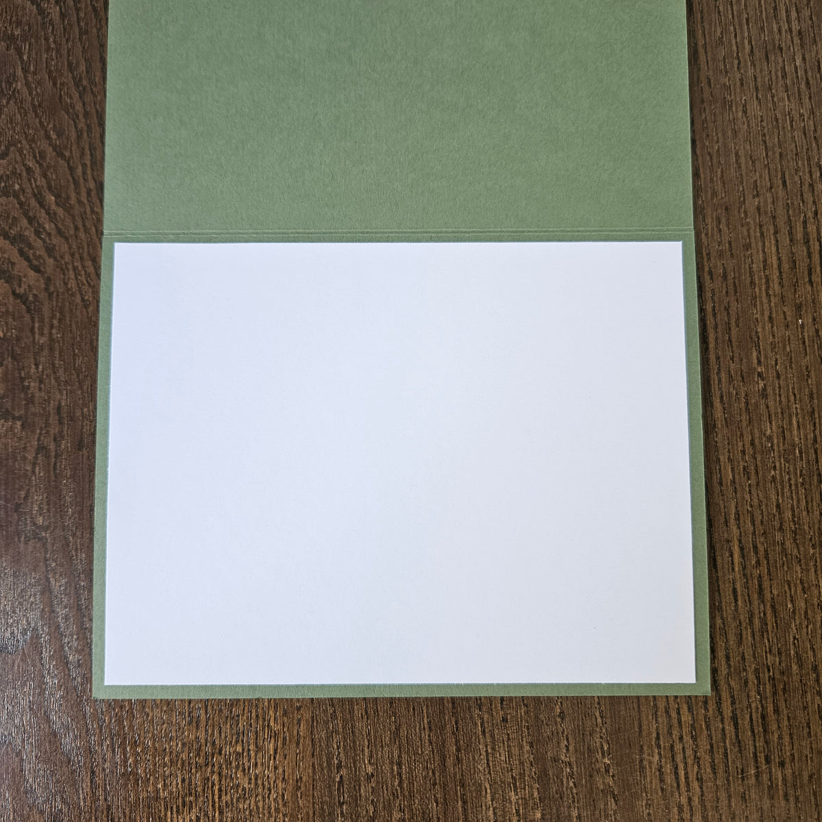 Open sage green card showing the blank white interior panel for a handwritten thank-you message.